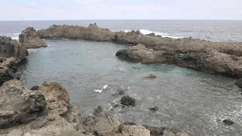 Natural lava pool by the ocean Stock Footage 106624670