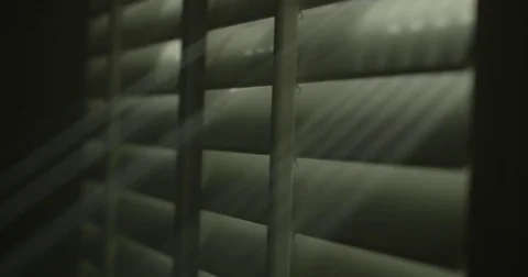 Natural light breaking through window shutter Stock Footage 76047739