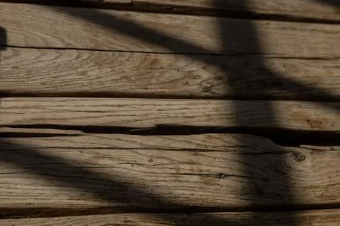 Natural light casting shadows across rustic wooden surface in a cozy indoor Stock Photos