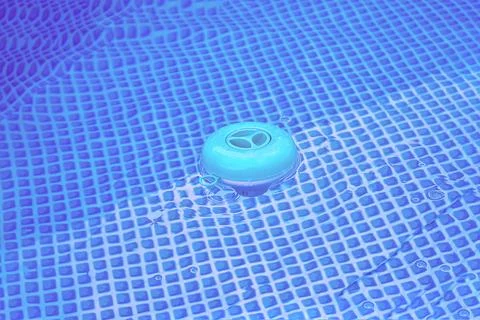 Natural light. frame pool. a container with solid tablets floats in the poo.. Stockfoto's