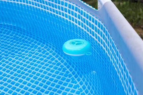 Natural light. frame pool. a container with solid tablets floats in the poo.. 스톡 사진