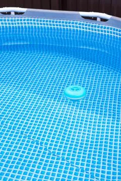 Natural light. frame pool. a container with solid tablets floats in the poo.. Stockfoto's