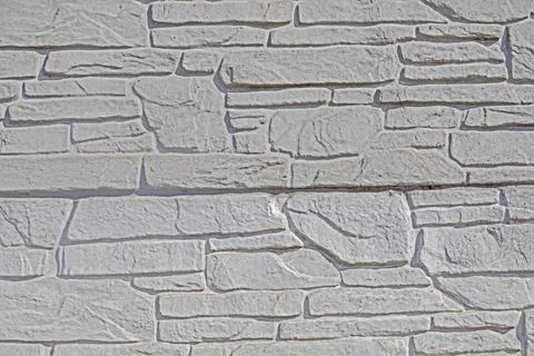 A natural light-gray concrete background with irregular geometric shapes Foto stock