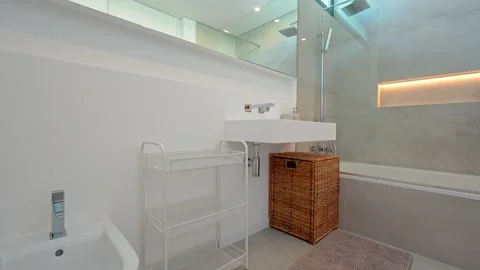 Natural light illuminates a sleek, modern bathroom as smart glass transitions Stock Footage 321371433
