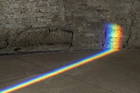 Natural Light refraction in Rainbow inside ancient stone building Stock Photos