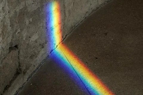 Natural Light refraction in Rainbow inside ancient stone building Stock Photos