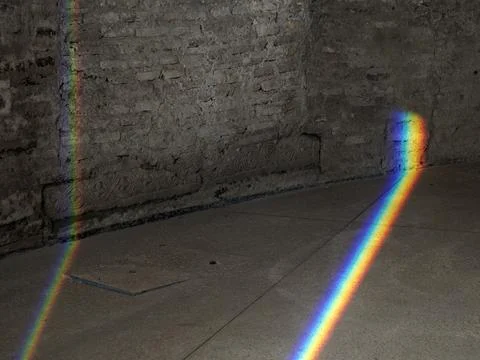 Natural Light refraction in Rainbow inside ancient stone building Stock Photos