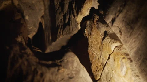 Natural limestone cave texture with stalactites and stalagmites in darkness. Stock Footage 321702146