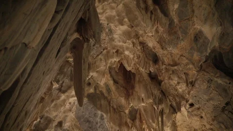 Natural limestone cave texture with stalactites and stalagmites in darkness. Stock Footage 321703417