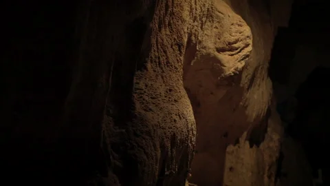 Natural limestone cave texture with stalactites and stalagmites in darkness. Stock Footage 321706726