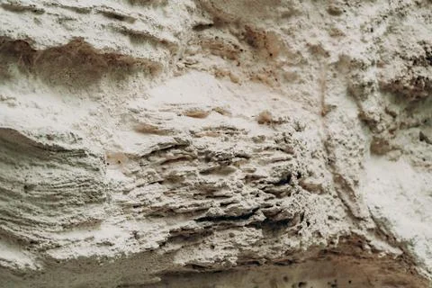 Natural limestone wall texture with layered erosion marks pale beige minera.. Stock Photos