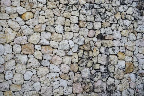 Natural limestone wall texture with sturdy rough stone arrangement Stock Photos