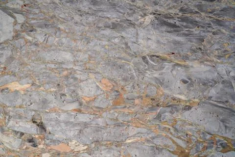 Natural marble texture with grey base and warm gold veining Stock Photos