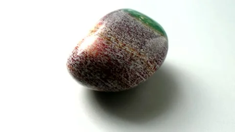 Natural multi-colored green red jasper stone Madagascar spins around its axis Stock Footage 152383563