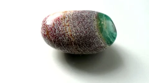 Natural multi-colored green red jasper stone Madagascar spins around its axis Stock Footage 152383591