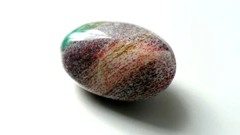 Natural multi-colored green red jasper stone Madagascar spins around its axis Stock Footage 152383723