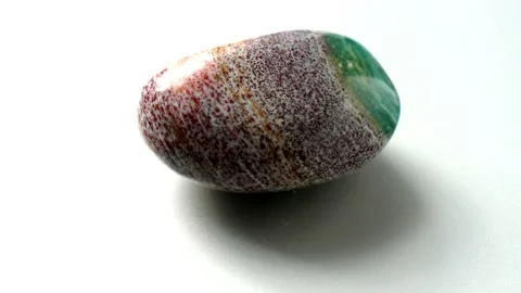 Natural multi-colored green red jasper stone Madagascar spins around its axis Stock Footage 152383748