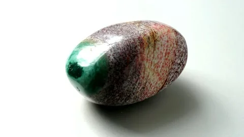 Natural multi-colored green red jasper stone Madagascar spins around its axis Stock Footage 152383826