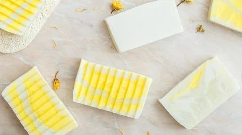 Natural olive soap bars pattern with herbs dry marigold flowers. Many various 스톡 사진