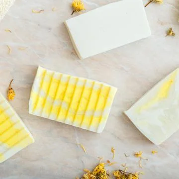 Natural olive soap bars pattern with herbs dry marigold flowers. Many various Stock Photos
