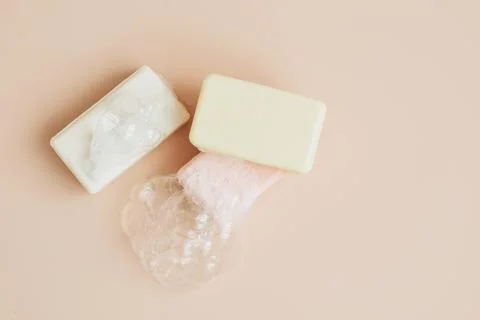 Natural organic handmade soap with large bubbles of foam on pastel background Stock Photos