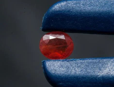 Natural oval red ruby on the black background Stock Photos