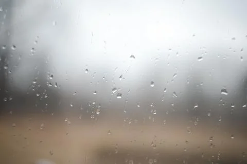 Natural pattern of rain drops on window glass surface. Stock Photos