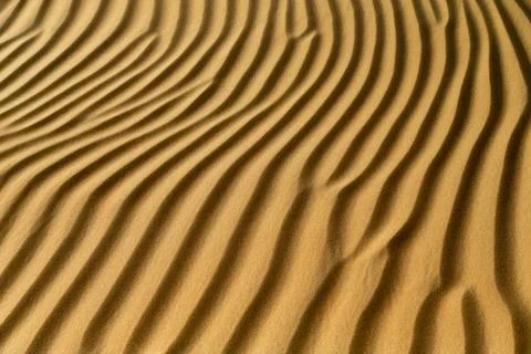 Natural pattern of the sand dune in the desert in Abu Dhabi. Closeup abstr... Stock Photos