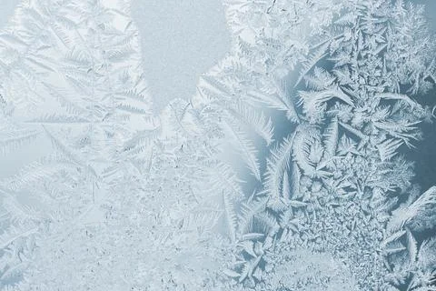 Natural patterns of a frost on a window glass, macro photo Stock Photos