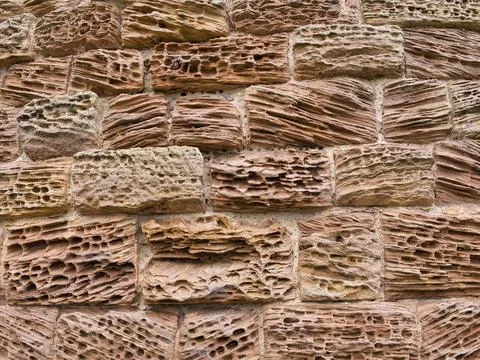 Natural patterns in sandstone blocks eroded by the action of the weather. Stock Photos