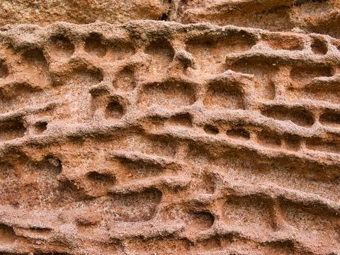 Natural patterns in sandstone eroded by the action of the weather. Stock Photos