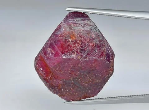 Natural pink red ruby gem on the background Stock Photos