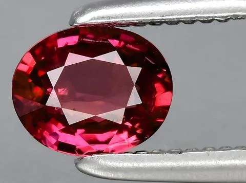Natural pink red ruby gem on the background Stock Photos