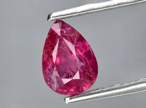 Natural pink red ruby gem on the background Stock Photos