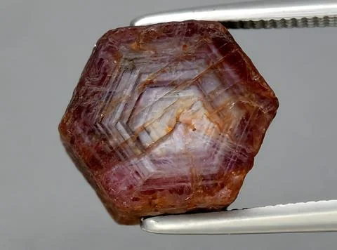 Natural pink red ruby gem on the background Stock Photos