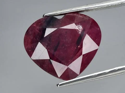 Natural pink red ruby gem on the background Stock Photos