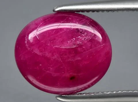 Natural pink red ruby gem on the background 스톡 사진
