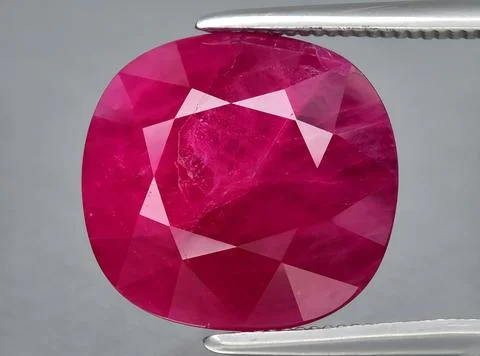 Natural pink red ruby gem on the background Stock Photos