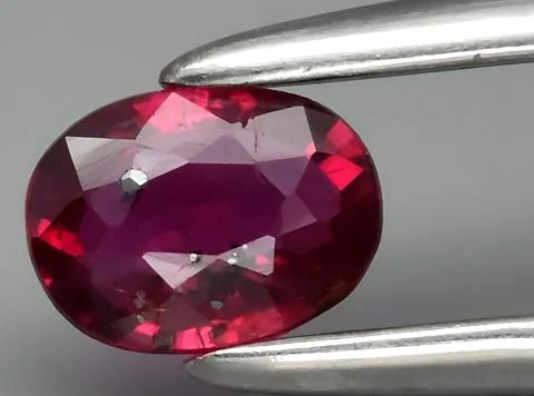 Natural pink red ruby gem on the background Stock Photos
