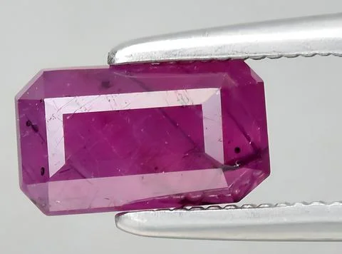 Natural pink red ruby gem on the background Stock Photos