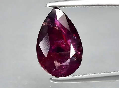 Natural pink red ruby gem on the background Stock Photos