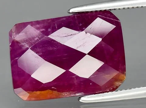 Natural pink red ruby gem on the background Stock Photos