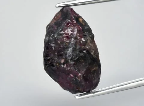 Natural pink red ruby gem on the background Stock Photos