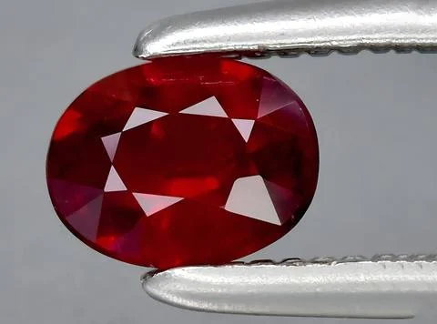 Natural pink red ruby gem on the background Stock Photos