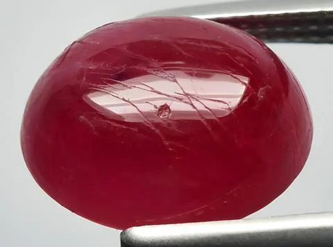 Natural pink red ruby gem on the background Stock Photos