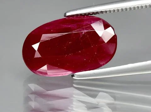 Natural pink red ruby gem on the background 스톡 사진