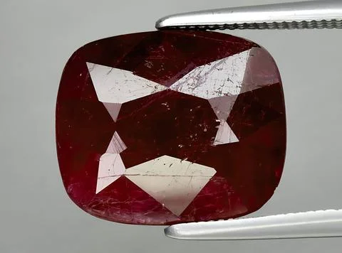 Natural pink red ruby gem on the background Stock Photos