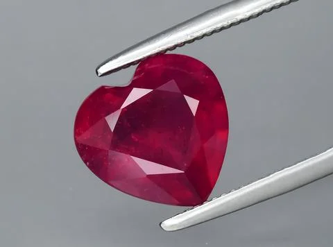Natural pink red ruby gem on the background Stock Photos