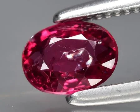 Natural pink red ruby gem on the background Stock Photos