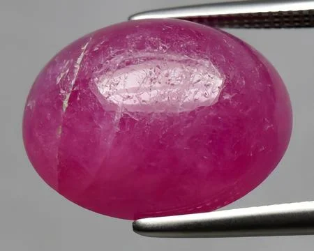 Natural pink red ruby gem on the background Stock Photos